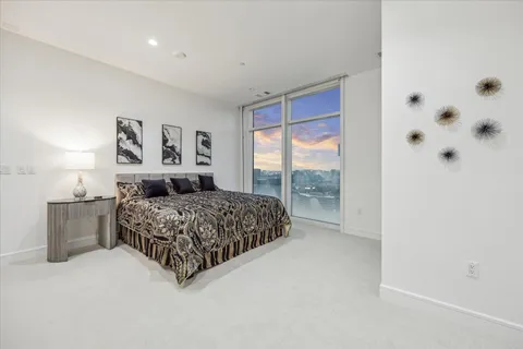 a bedroom with furniture and a large window