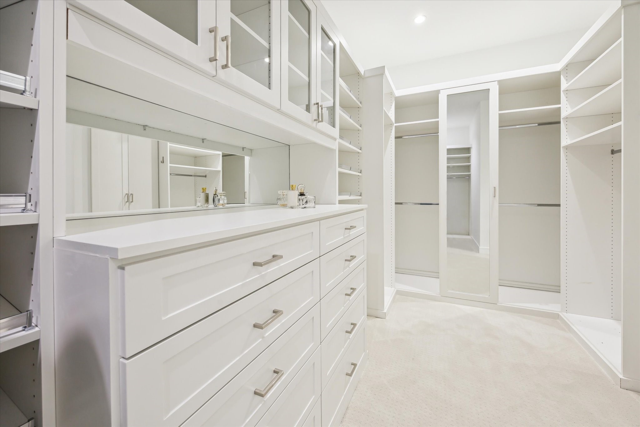 4521 San Felipe Street, Unit 23045 Houston, TX 77027 - Photo 15 of 25 Custom built, primary closet has an abundance of built in, chrome rods, adjustable shelving, single and double hung racks. Mirror accents add a feel of luxury.