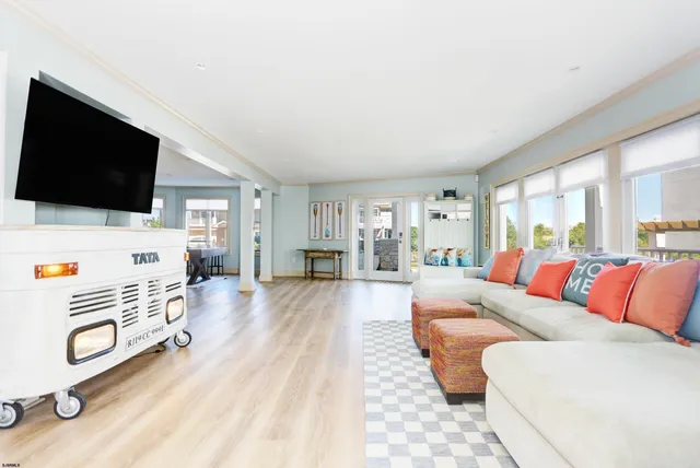 a kitchen with a sink stove and wooden floor