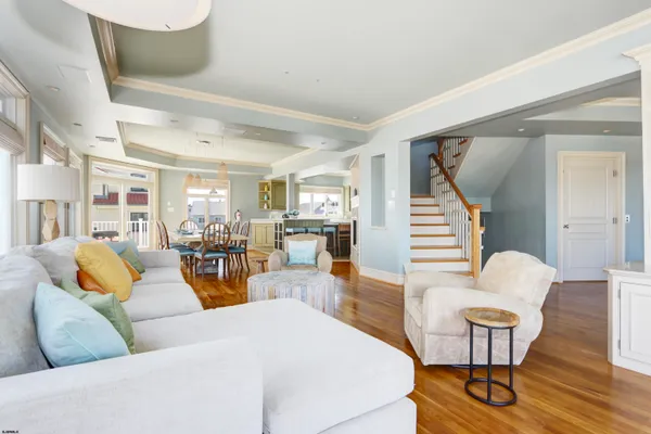 a view of a dining room with furniture a chandelier and wooden floor