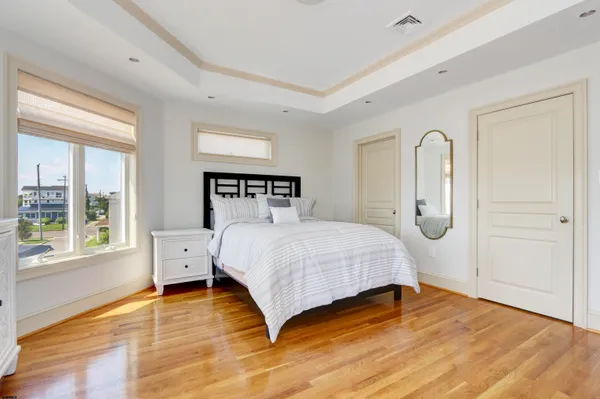a bedroom with furniture and a wooden floor