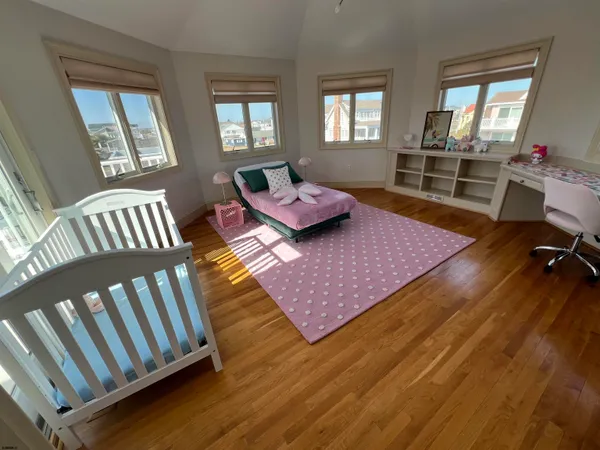 a kitchen with stainless steel appliances granite countertop a refrigerator a stove top oven a sink dishwasher and white cabinets with wooden floor