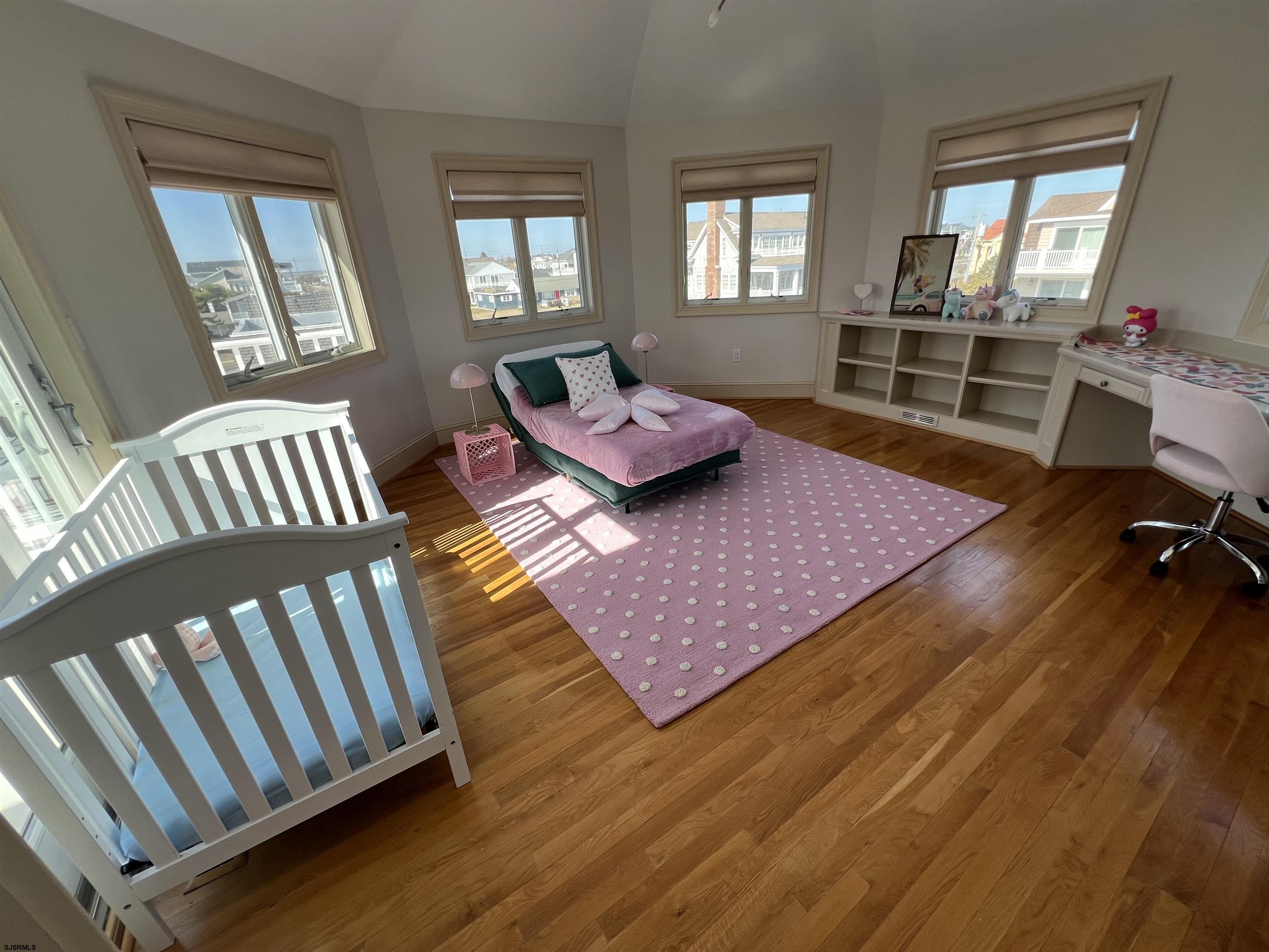 402 20th Street South Brigantine, NJ 08203 - Photo 28 of 59 a bedroom with furniture and a wooden floor