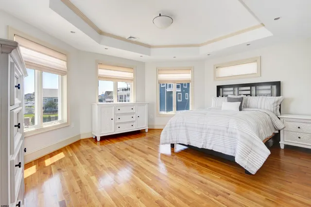 a spacious bedroom with a bed and large windows