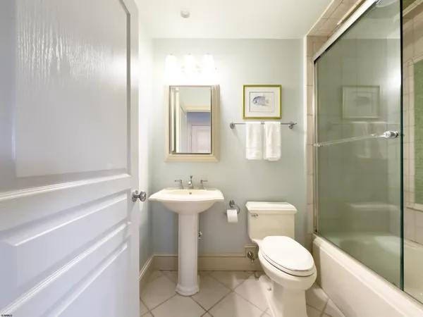 a large bedroom with a bed and wooden floor