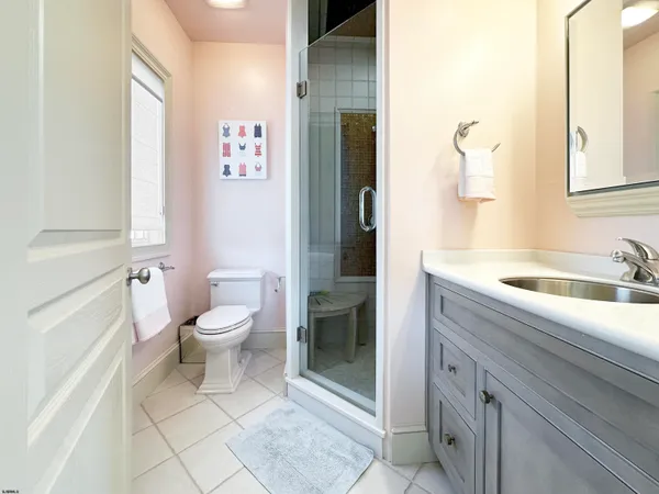 a bathroom with a granite countertop sink and a bathtub