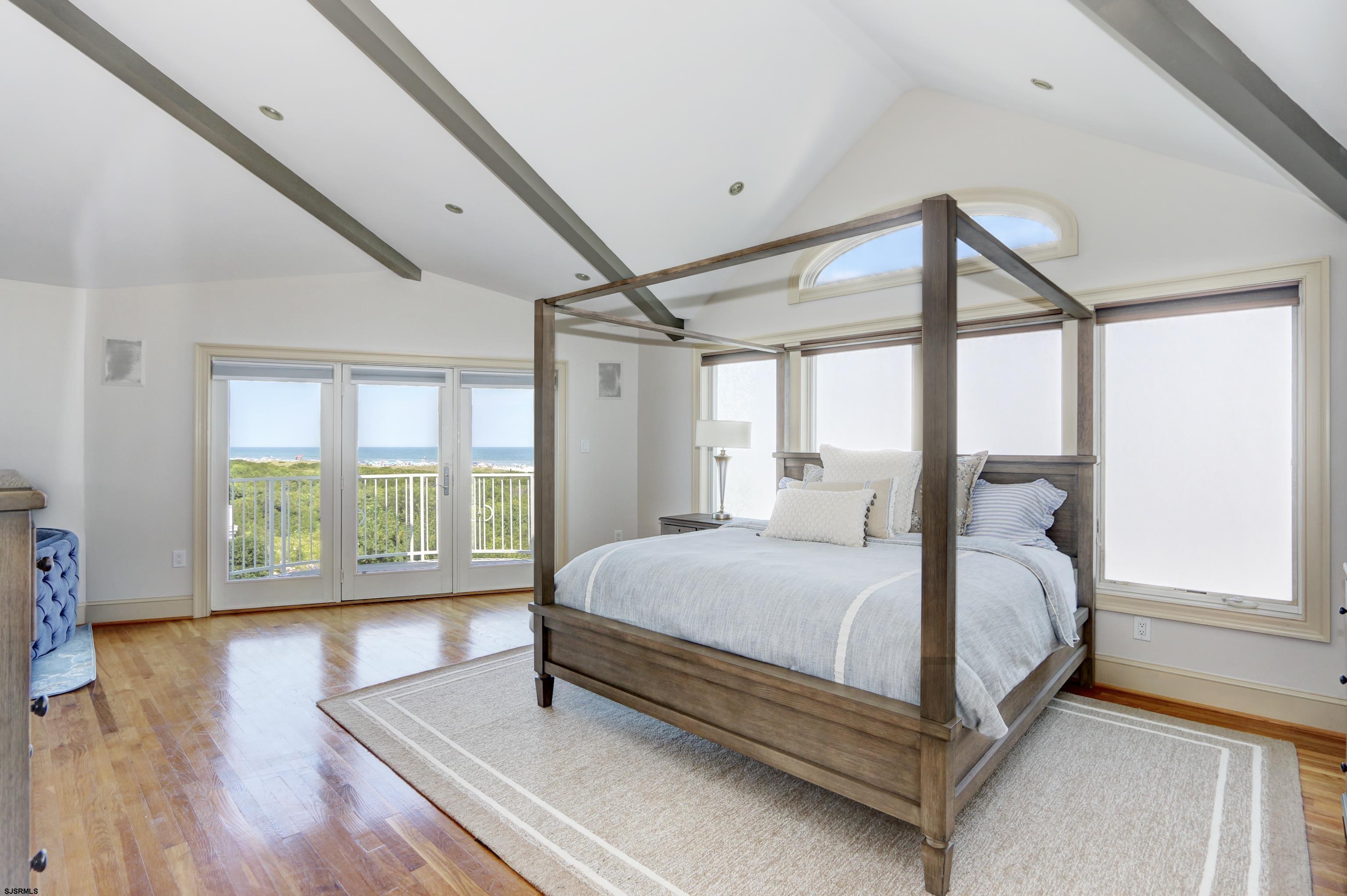 402 20th Street South Brigantine, NJ 08203 - Photo 54 of 59 a large bedroom with a bed and wooden floor