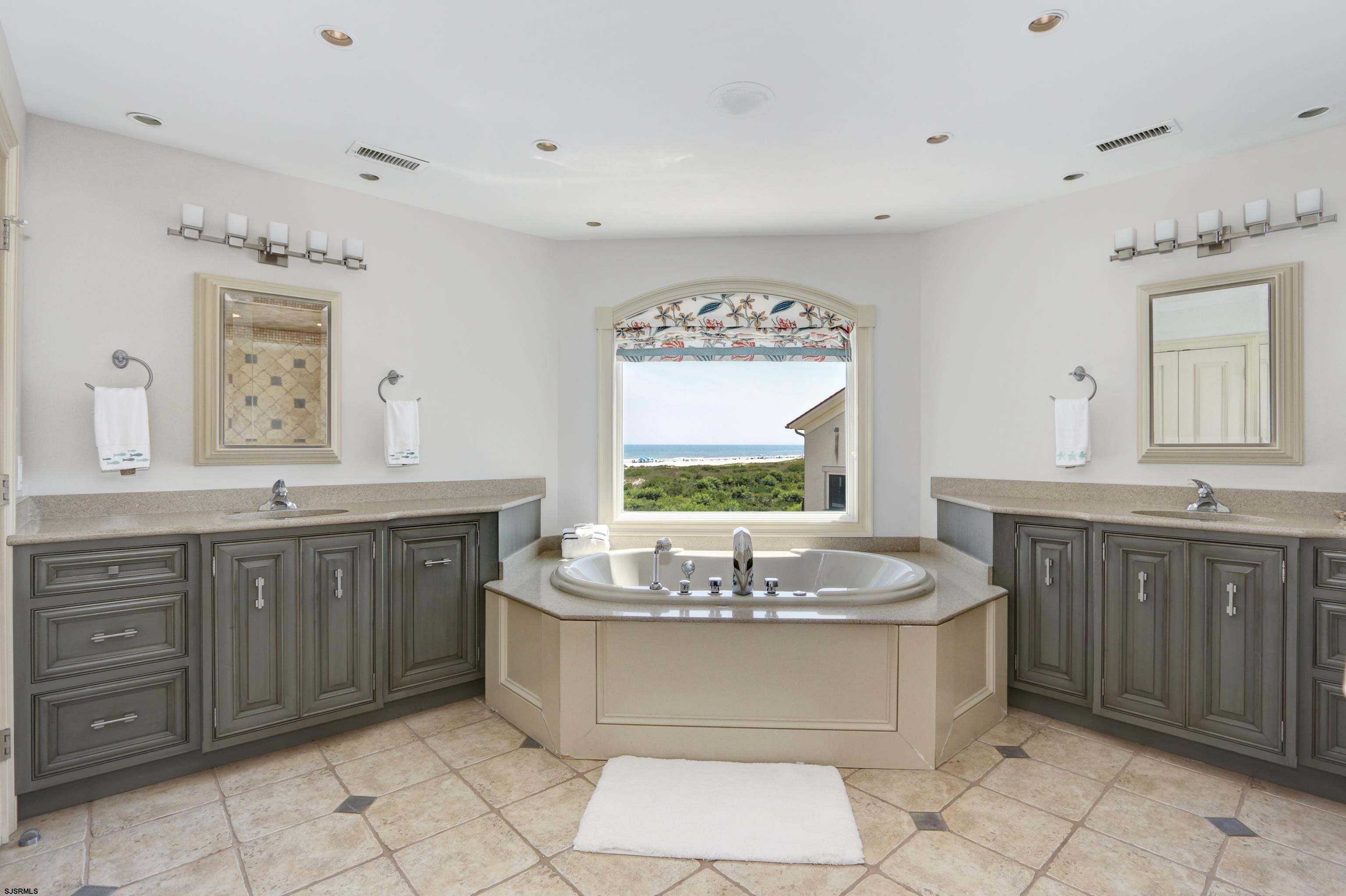 402 20th Street South Brigantine, NJ 08203 - Photo 57 of 59 a bathroom with a granite countertop sink and a bathtub