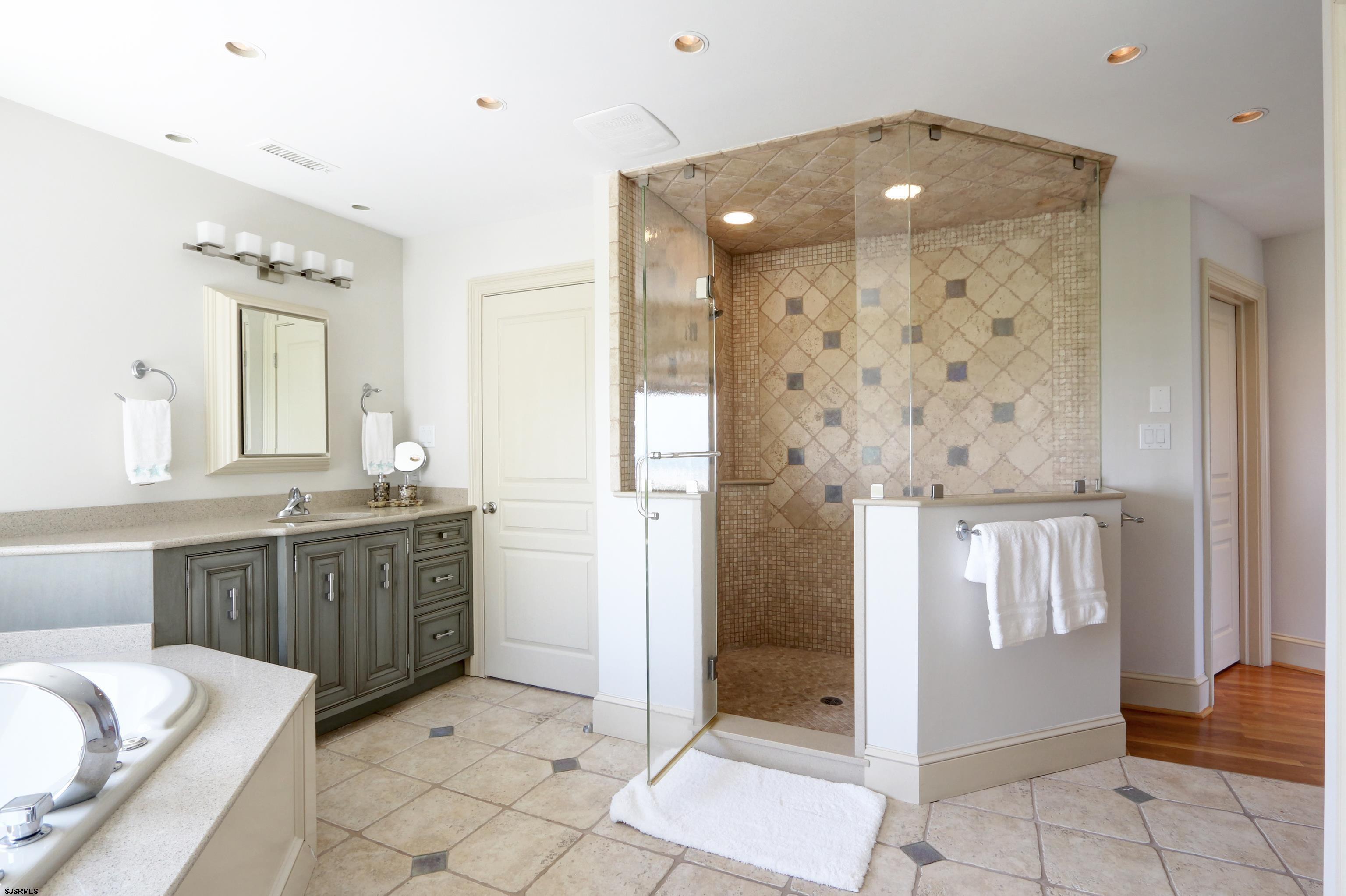 402 20th Street South Brigantine, NJ 08203 - Photo 58 of 59 a bathroom with a granite countertop sink a mirror and a shower