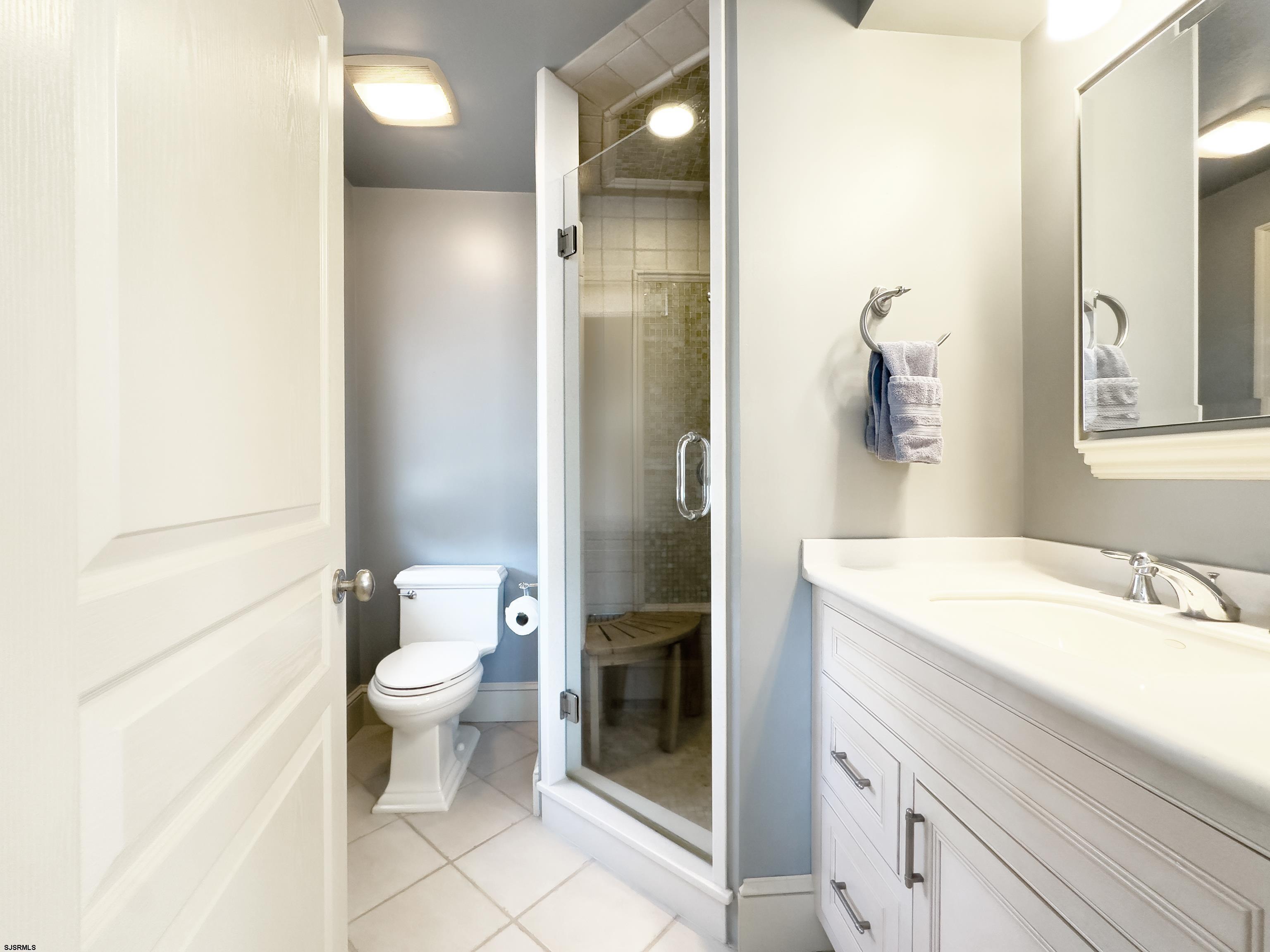 402 20th Street South Brigantine, NJ 08203 - Photo 7 of 59 a bathroom with a sink a toilet and shower