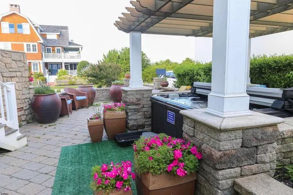 a view of a patio with table and chairs and potted plants