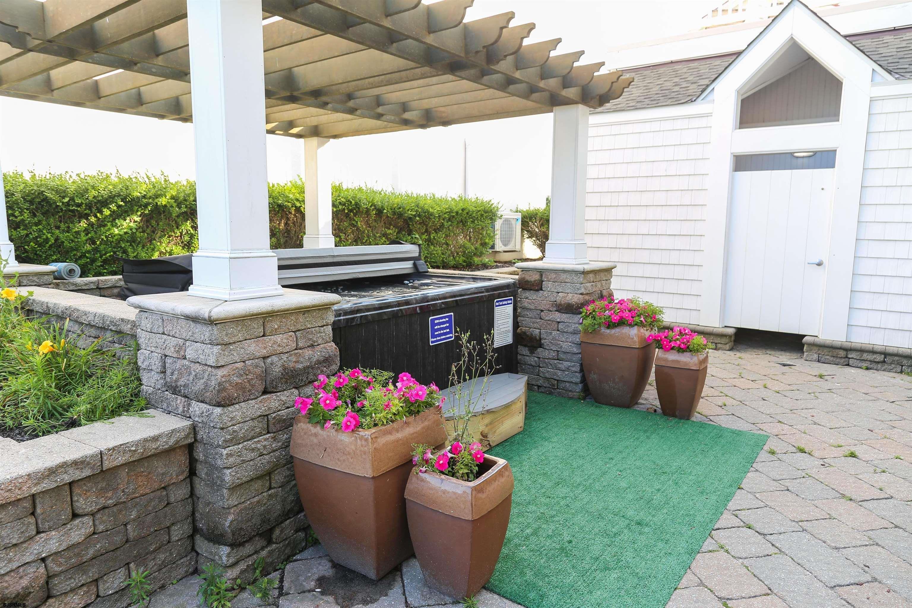 402 20th Street South Brigantine, NJ 08203 - Photo 10 of 59 a view of a patio with table and chairs and potted plants