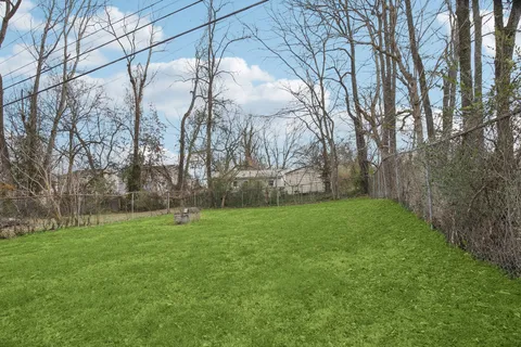 a view of a house with a backyard and porch