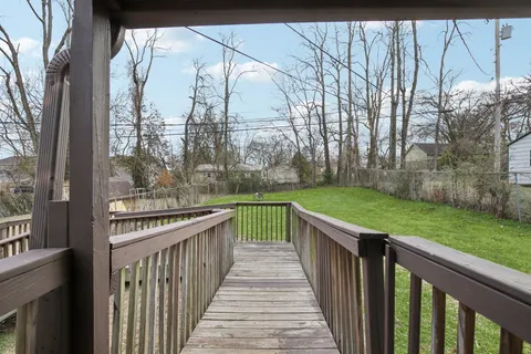 a view of a house with wooden deck