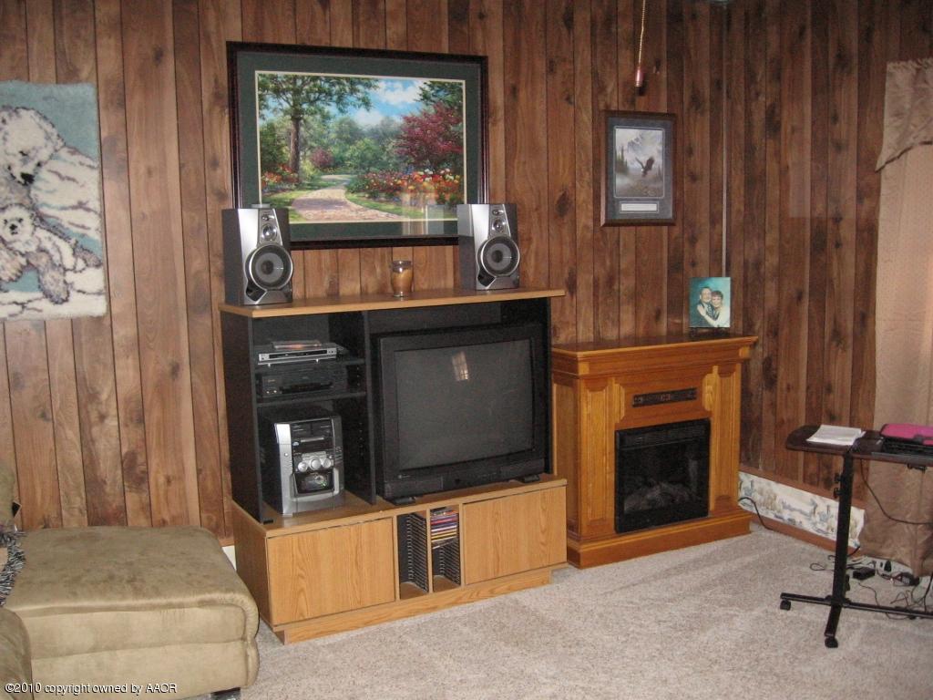 4620 South Hayden Street Amarillo, TX 79110 - Photo 7 of 12 a living room with fireplace furniture and a window