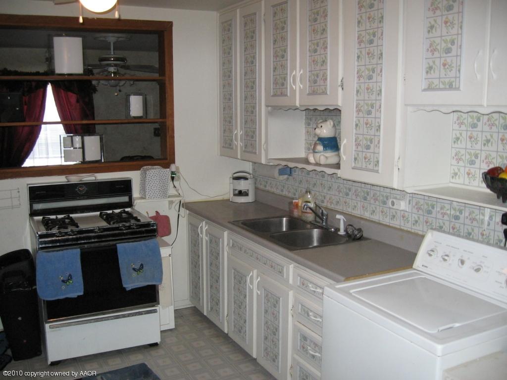 4620 South Hayden Street Amarillo, TX 79110 - Photo 8 of 12 a kitchen with a sink stove and cabinets