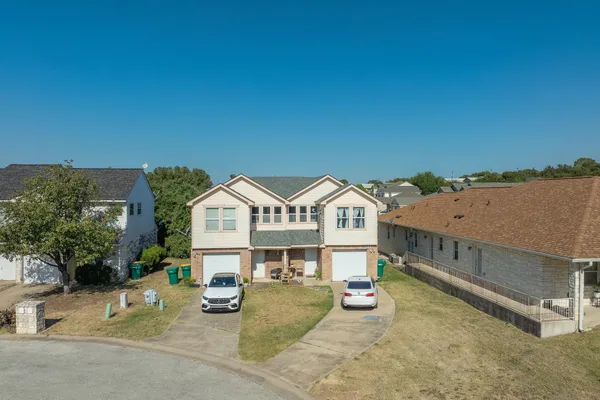 an aerial view of a house with swimming pool and furniture