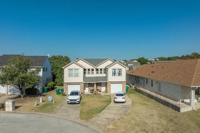an aerial view of a house with swimming pool and furniture