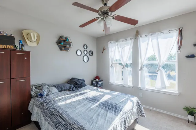 a bedroom with a bed and a window