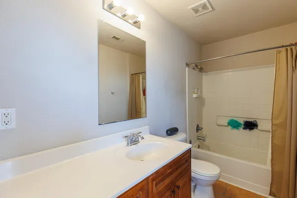a bathroom with a sink mirror toilet and bathtub