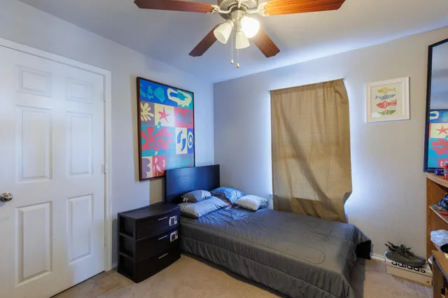 a bedroom with a bed and a chandelier
