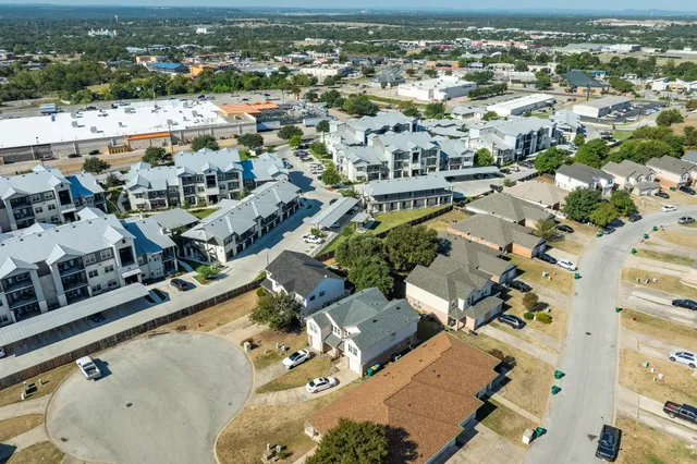 an aerial view of residential houses with outdoor space