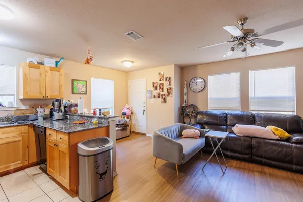 a living room with furniture and wooden floor