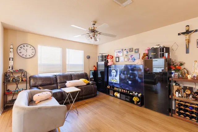 a living room with furniture a wooden floor and a chandelier