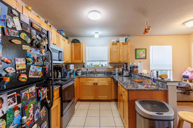 a kitchen that has a lot of cabinets in it