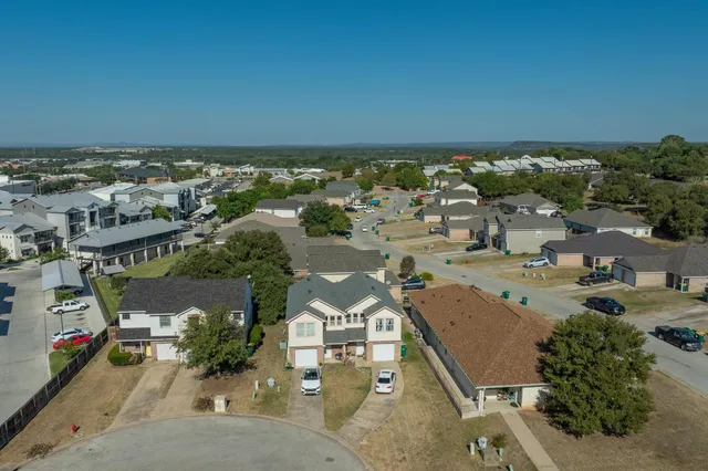 an aerial view of a house with a yard