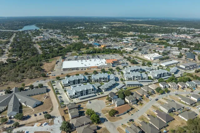 an aerial view of residential building and lake