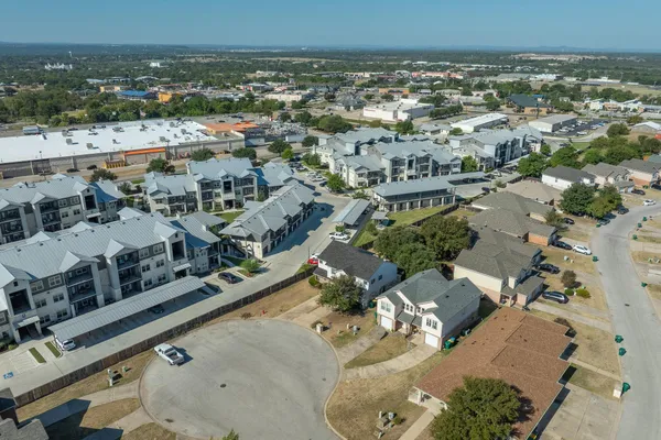 an aerial view of residential building with parking