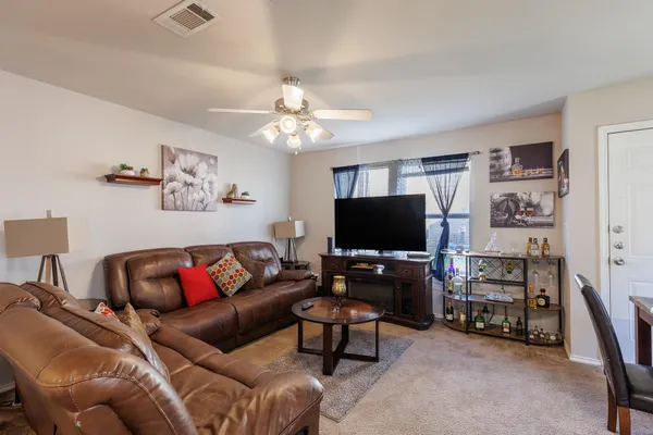 a living room with furniture and a flat screen tv