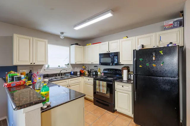 a kitchen with a refrigerator a stove a sink dishwasher and a refrigerator