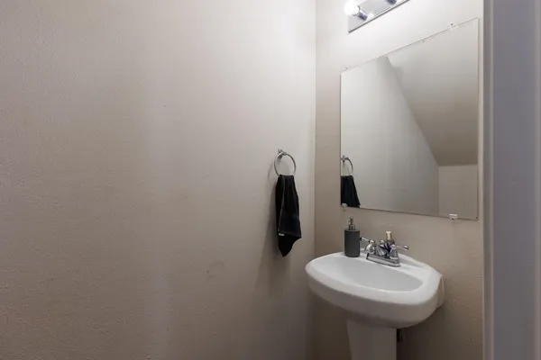 a bathroom with a sink a mirror and a toilet