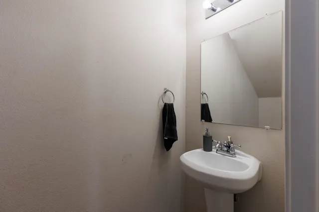 a bathroom with a sink a mirror and a toilet
