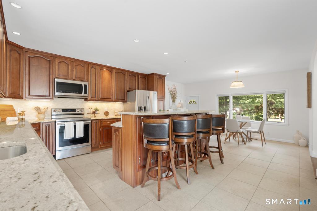 120 Saddleview Road Fairfield, CT 06825 - Photo 21 of 40 Center island with ample seating, 2nd sink, & extra prep space.