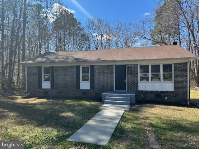 26022 Zion Road Ruther Glen, VA 22546 - Photo 1 of 21 a front view of a house with a yard and garage
