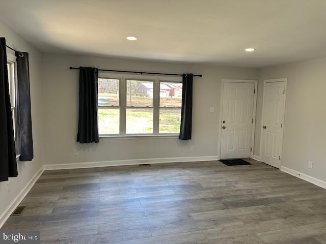 26022 Zion Road Ruther Glen, VA 22546 - Photo 4 of 21 an empty room with wooden floor and a window