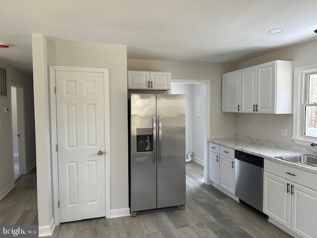 26022 Zion Road Ruther Glen, VA 22546 - Photo 6 of 21 a kitchen with stainless steel appliances granite countertop a refrigerator and white cabinets