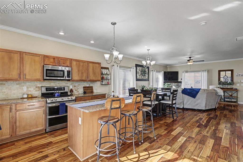 7858 Chasewood Loop Colorado Springs, CO 80908 - Photo 11 of 40 a large kitchen with a table and chairs
