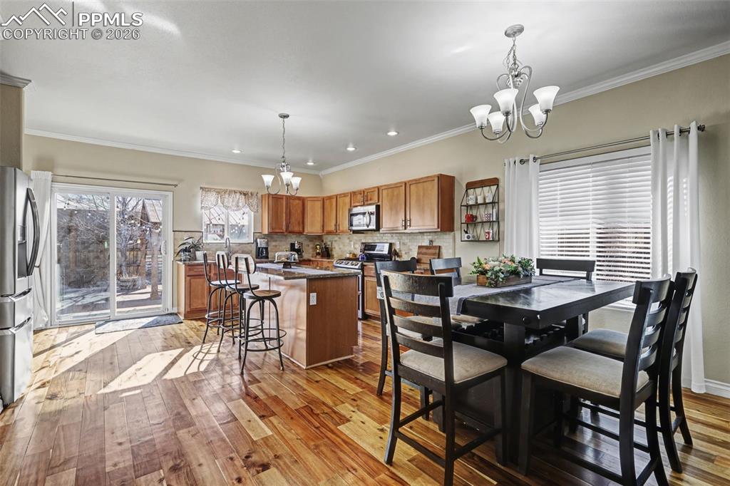 7858 Chasewood Loop Colorado Springs, CO 80908 - Photo 12 of 40 a view of a dining room with furniture window and outside view