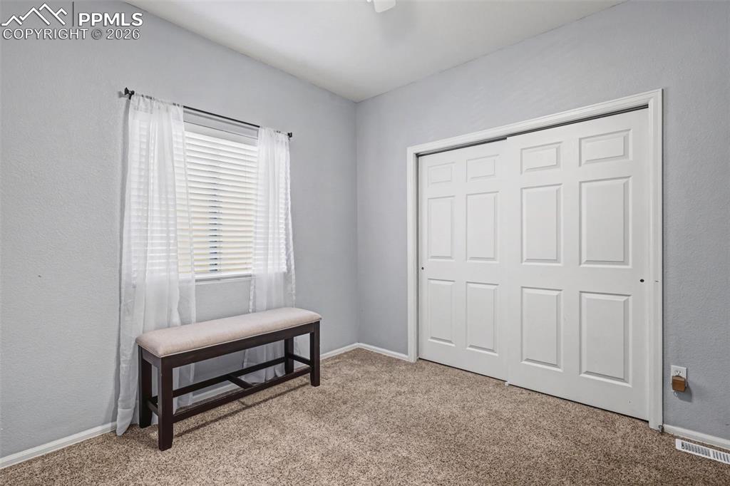 7858 Chasewood Loop Colorado Springs, CO 80908 - Photo 23 of 40 a living room with furniture and a window