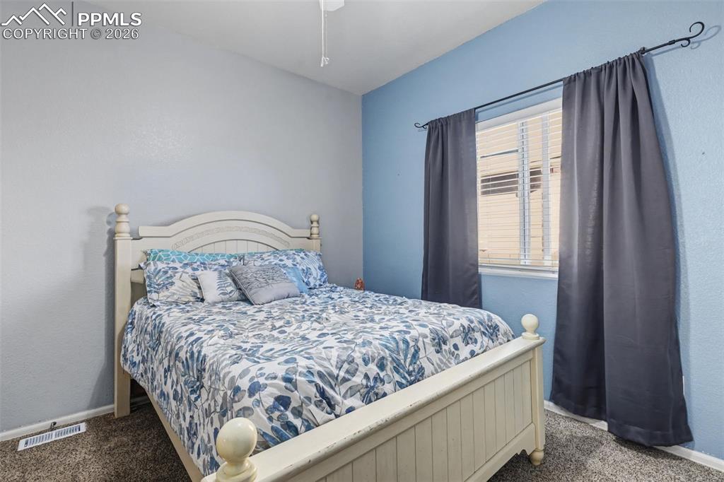 7858 Chasewood Loop Colorado Springs, CO 80908 - Photo 25 of 40 a large bed sitting in a bedroom next to a window