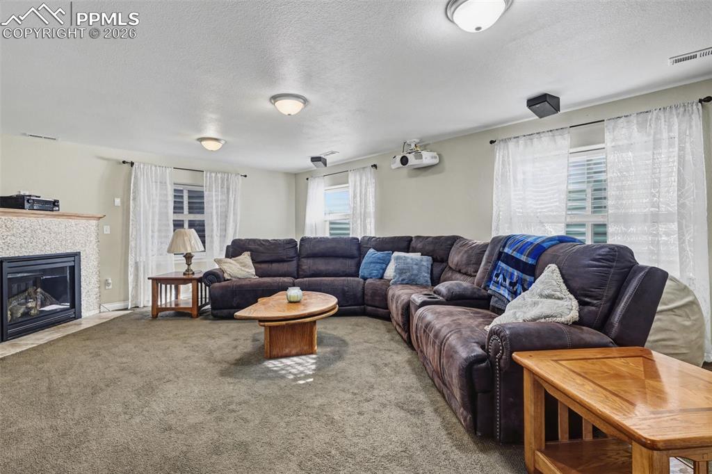 7858 Chasewood Loop Colorado Springs, CO 80908 - Photo 26 of 40 a living room with furniture and a fireplace