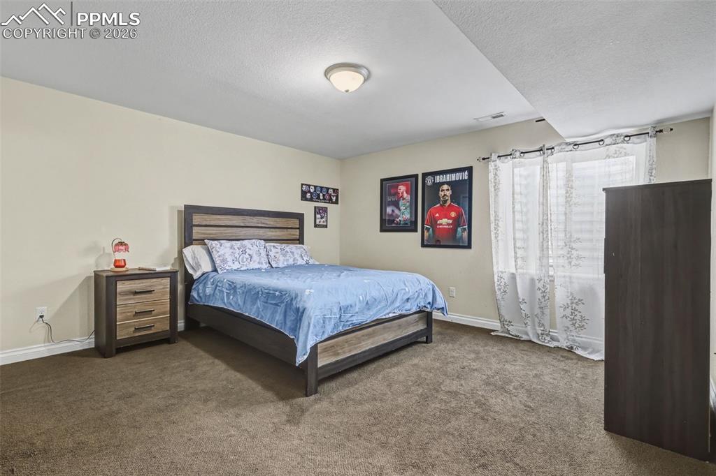 7858 Chasewood Loop Colorado Springs, CO 80908 - Photo 30 of 40 a bedroom with a bed dresser and a window