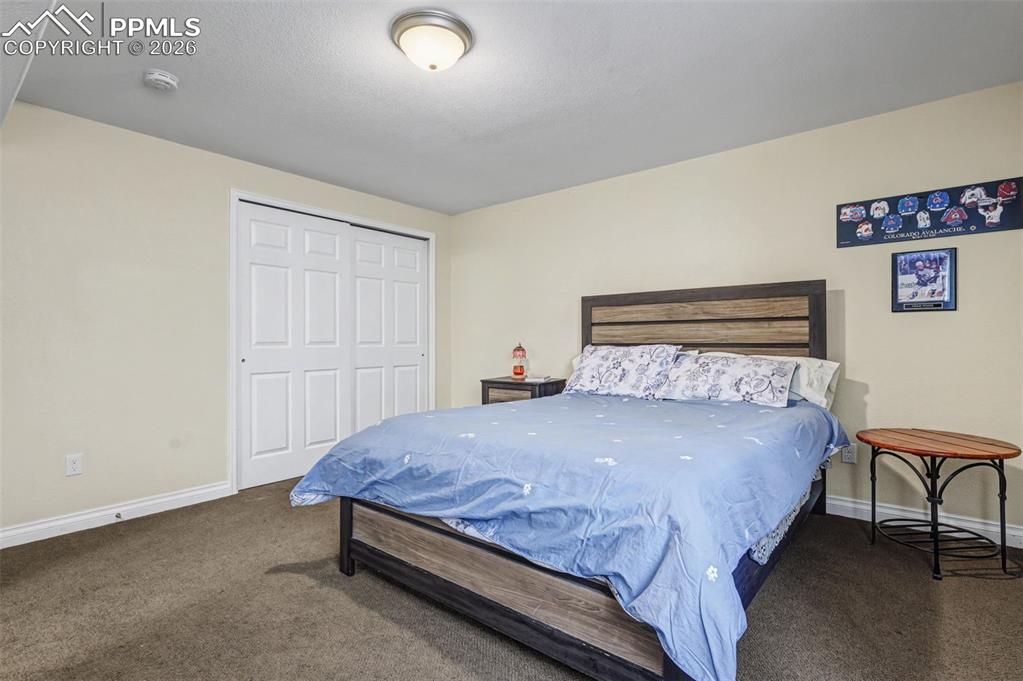 7858 Chasewood Loop Colorado Springs, CO 80908 - Photo 31 of 40 a bedroom with a bed and chair
