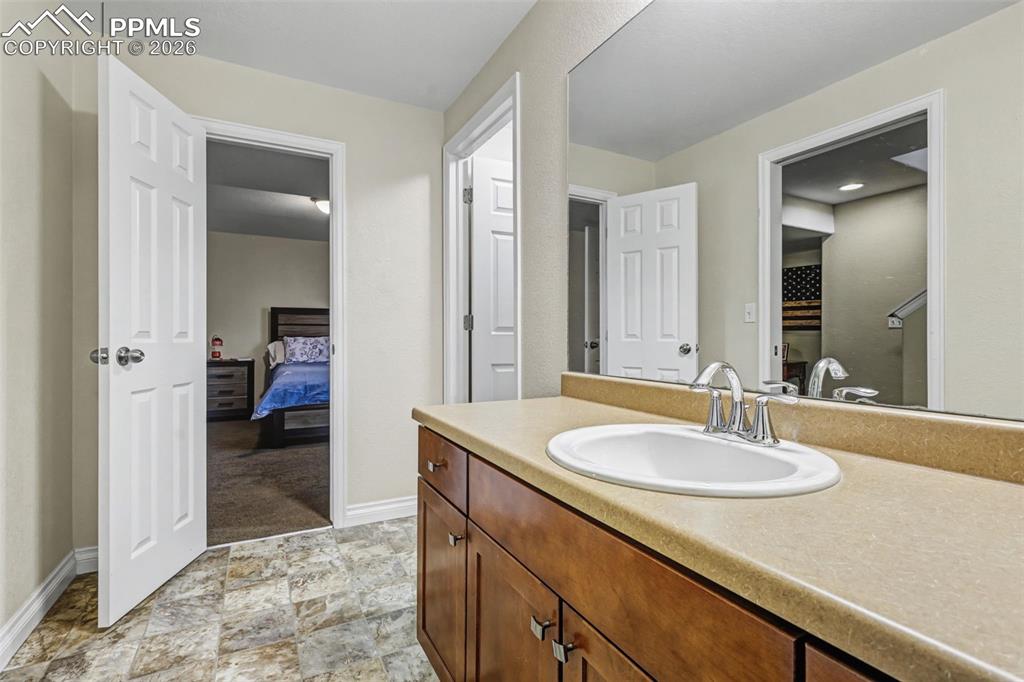 7858 Chasewood Loop Colorado Springs, CO 80908 - Photo 33 of 40 a en suite bathroom with a sink and a mirror