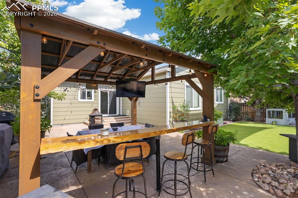 7858 Chasewood Loop Colorado Springs, CO 80908 - Photo 36 of 40 a patio with table and chairs