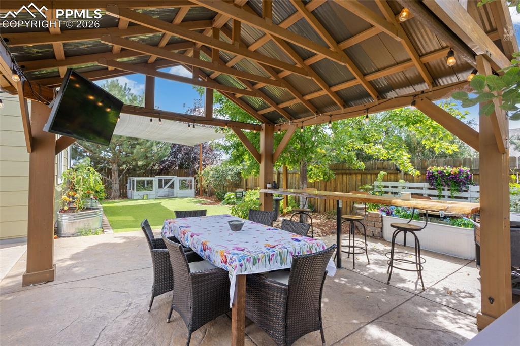 7858 Chasewood Loop Colorado Springs, CO 80908 - Photo 37 of 40 a view of a patio with a table chairs and a backyard